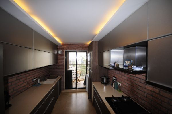 Corridor Kitchen with Cabinets & Brick Finish over the Kitchen Walls